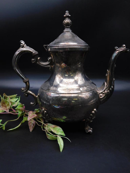 Silver-Plated Teapot with Ornate Design and Hinged Lid